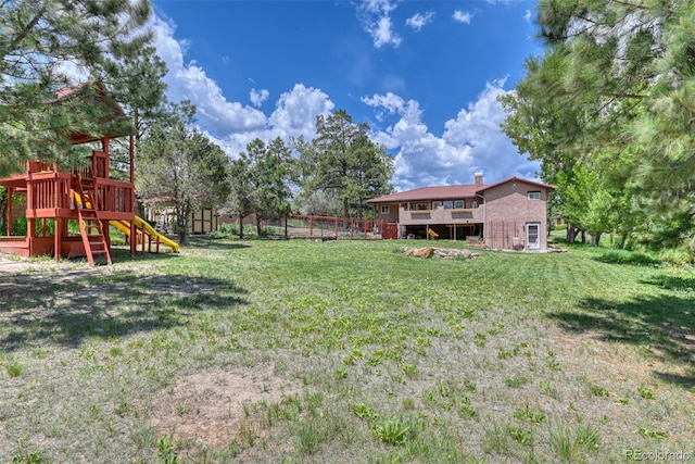 view of yard with a storage unit and a playground