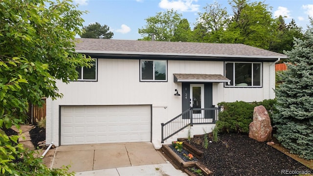 13249 W Jewell Pl, Lakewood, CO 80228 - raised ranch featuring a shingled roof, driveway, and an attached garage
