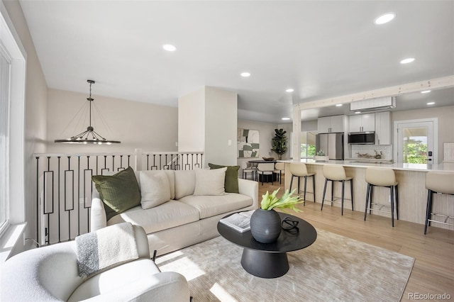 13249 W Jewell Pl, Lakewood, CO 80228 - living area with light wood-type flooring, recessed lighting, and a chandelier
