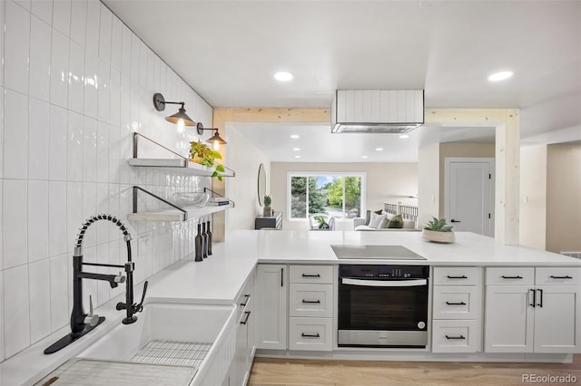 13249 W Jewell Pl, Lakewood, CO 80228 - kitchen featuring oven, black electric cooktop, open shelves, light countertops, and recessed lighting