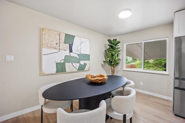 13249 W Jewell Pl, Lakewood, CO 80228 - dining space with baseboards and light wood finished floors