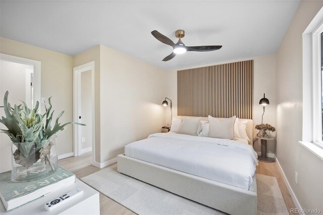 13249 W Jewell Pl, Lakewood, CO 80228 - bedroom with light wood finished floors and a ceiling fan
