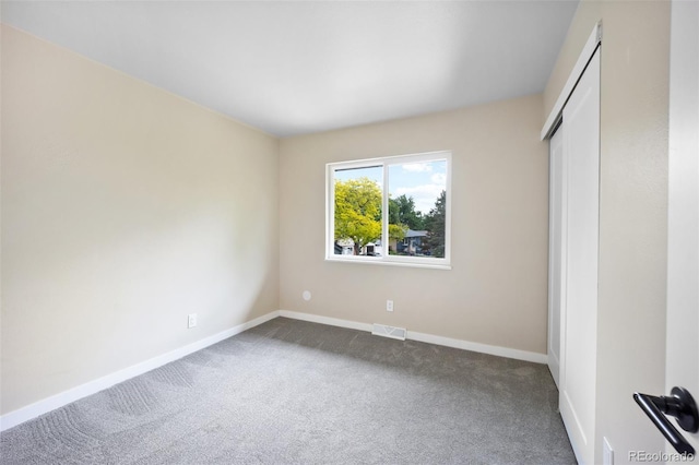 13249 W Jewell Pl, Lakewood, CO 80228 - unfurnished bedroom featuring dark colored carpet and a closet