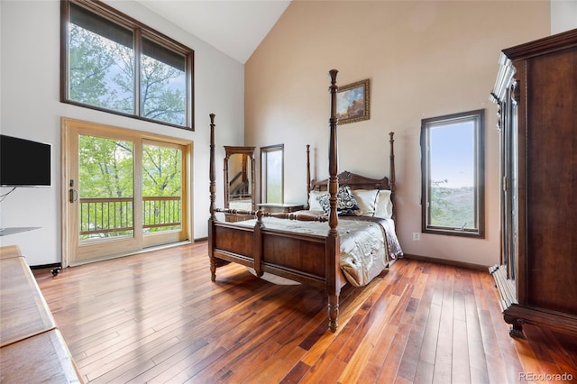 3900 Bogey Ct, Longmont, CO 80503 - bedroom with high vaulted ceiling, access to exterior, and light wood-style flooring