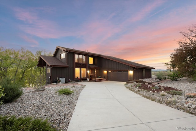 3900 Bogey Ct, Longmont, CO 80503 - mid-century home featuring a garage, driveway, and board and batten siding