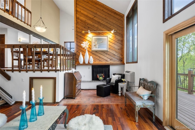 3900 Bogey Ct, Longmont, CO 80503 - living room featuring a high ceiling, plenty of natural light, stairway, wood finished floors, and a fireplace with raised hearth