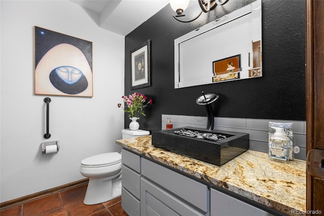 3900 Bogey Ct, Longmont, CO 80503 - bathroom with vanity, toilet, baseboards, and tile patterned floors
