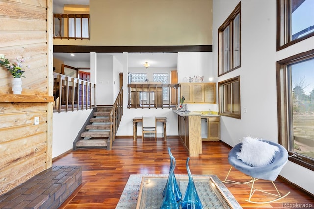 3900 Bogey Ct, Longmont, CO 80503 - living area with a high ceiling, wood finished floors, baseboards, and stairs