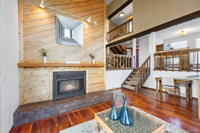3900 Bogey Ct, Longmont, CO 80503 - living area with wood-type flooring, stairway, and a fireplace