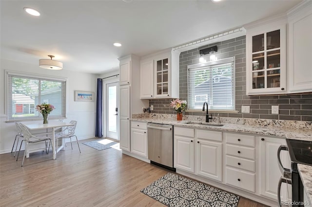 6179 S Bemis St, Littleton, CO 80120 - kitchen with stainless steel dishwasher, a sink, electric range, decorative backsplash, and white cabinets