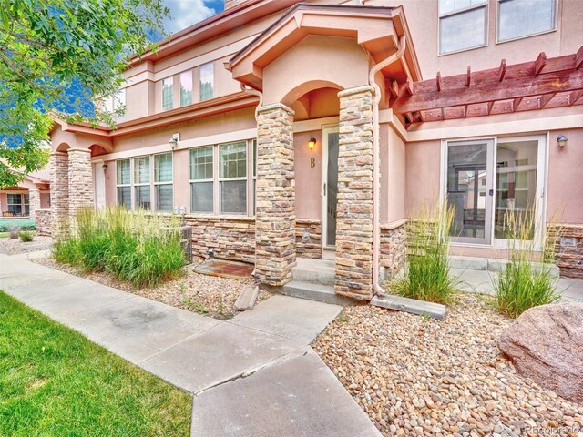 15501 E 112th Ave Unit 35B, Commerce City, CO 80022 - property entrance with stucco siding and stone siding