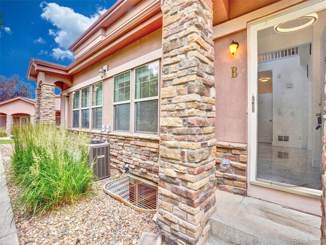 15501 E 112th Ave Unit 35B, Commerce City, CO 80022 - doorway to property with stone siding