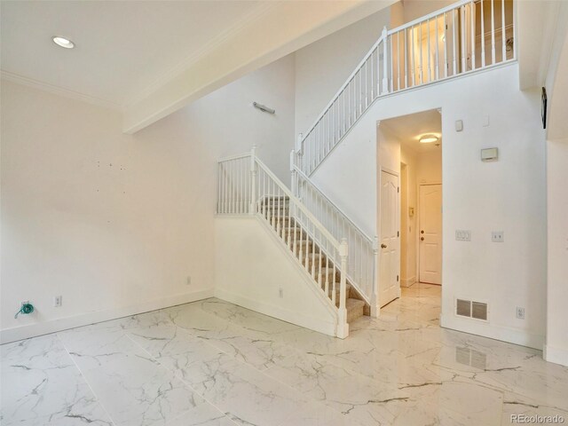 15501 E 112th Ave Unit 35B, Commerce City, CO 80022 - unfurnished living room with stairs, marble finish flooring, recessed lighting, and crown molding