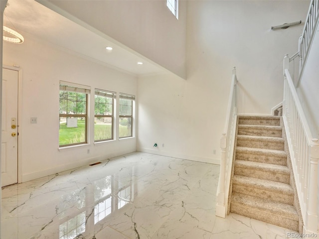 15501 E 112th Ave Unit 35B, Commerce City, CO 80022 - staircase featuring marble tiled floors, ornamental molding, recessed lighting, and a towering ceiling