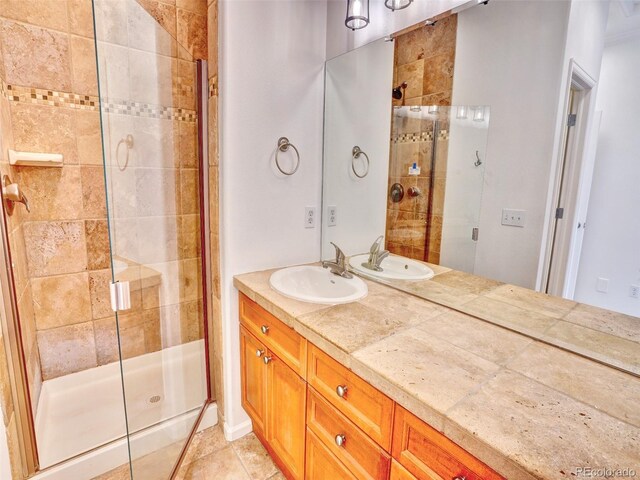 15501 E 112th Ave Unit 35B, Commerce City, CO 80022 - bathroom with a stall shower, double vanity, and tile patterned flooring