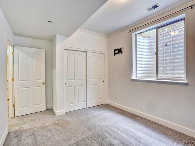 15501 E 112th Ave Unit 35B, Commerce City, CO 80022 - unfurnished bedroom with carpet floors, multiple windows, a closet, and crown molding
