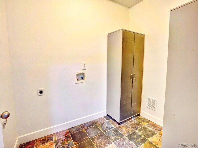 15501 E 112th Ave Unit 35B, Commerce City, CO 80022 - washroom with stone finish flooring, washer hookup, and hookup for an electric dryer