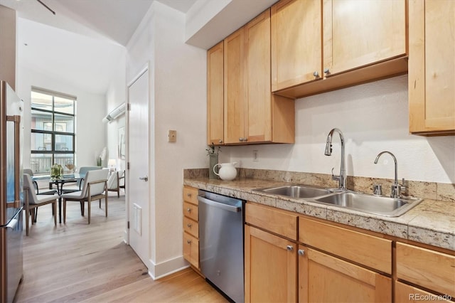 kitchen featuring stainless steel appliances, light hardwood / wood-style floors, sink, and light brown cabinets