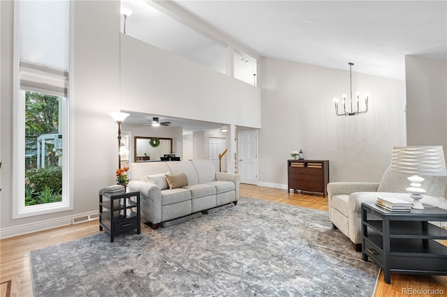 8535 E Otero Cir, Centennial, CO 80112 - living room featuring wood finished floors, a chandelier, baseboards, and high vaulted ceiling