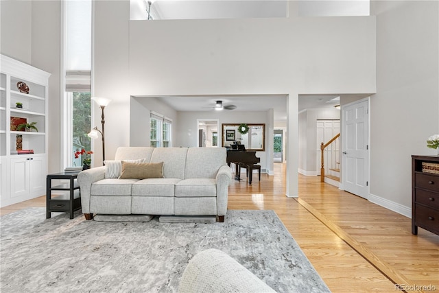 8535 E Otero Cir, Centennial, CO 80112 - living area with a high ceiling, light wood-style floors, stairs, and ceiling fan