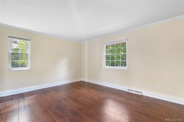 8535 E Otero Cir, Centennial, CO 80112 - empty room featuring healthy amount of natural light, baseboards, dark wood-style floors, and crown molding