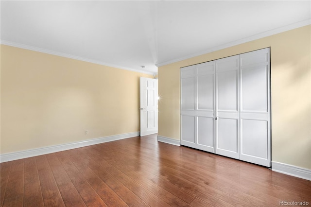 8535 E Otero Cir, Centennial, CO 80112 - unfurnished bedroom with ornamental molding, baseboards, wood finished floors, and a closet