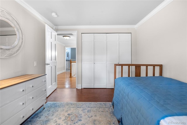 8535 E Otero Cir, Centennial, CO 80112 - bedroom with ornamental molding, dark wood finished floors, a closet, and baseboards