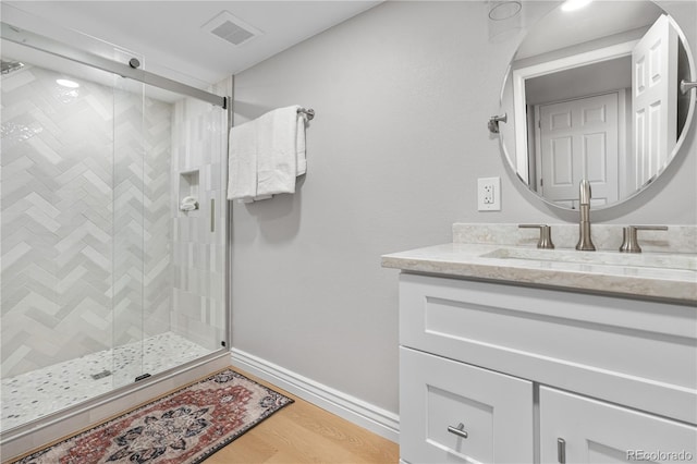 8535 E Otero Cir, Centennial, CO 80112 - full bathroom with vanity, a shower stall, wood finished floors, and baseboards