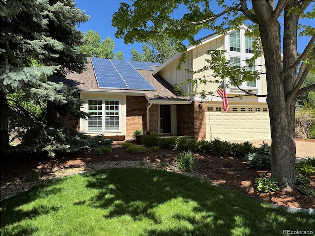 8535 E Otero Cir, Centennial, CO 80112 - view of front of home featuring brick siding, board and batten siding, roof mounted solar panels, an attached garage, and a front yard