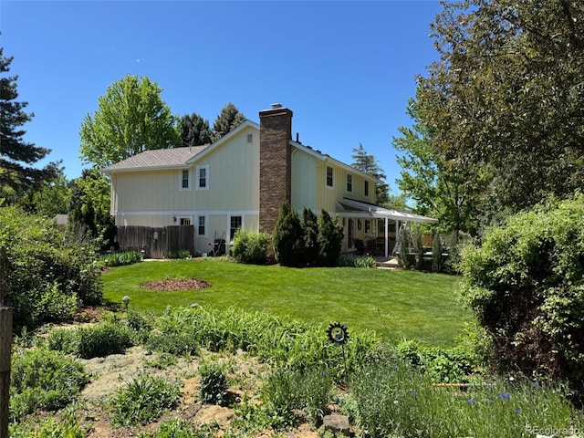 8535 E Otero Cir, Centennial, CO 80112 - rear view of property featuring a chimney and a lawn