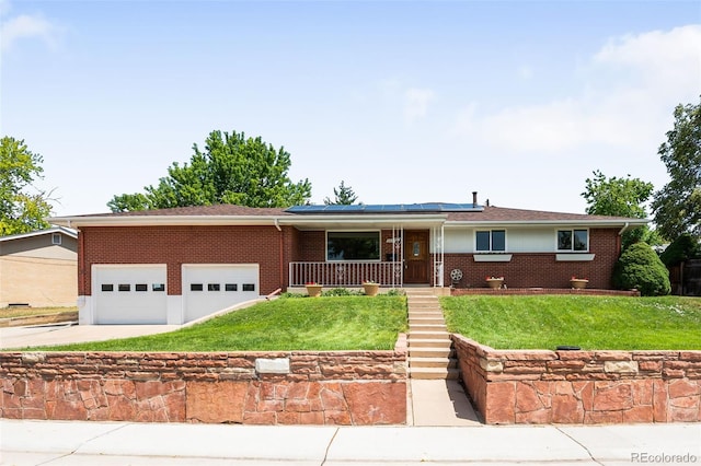 5947 W 65th Ave, Arvada, CO 80003 - ranch-style home featuring roof mounted solar panels, brick siding, covered porch, and a front yard