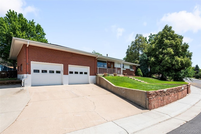 5947 W 65th Ave, Arvada, CO 80003 - ranch-style house with driveway, an attached garage, a front lawn, and brick siding