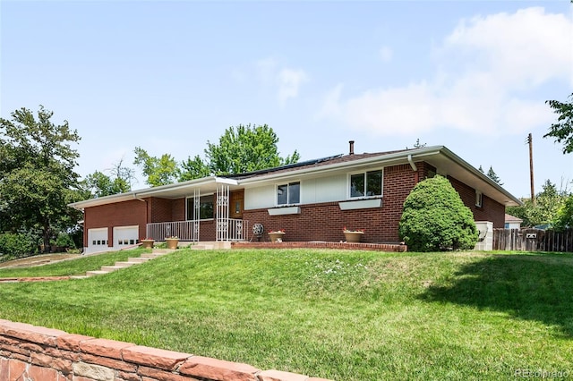 5947 W 65th Ave, Arvada, CO 80003 - single story home featuring brick siding, a garage, a porch, and a front lawn