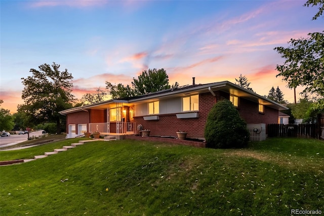 5947 W 65th Ave, Arvada, CO 80003 - ranch-style home featuring brick siding, an attached garage, and driveway