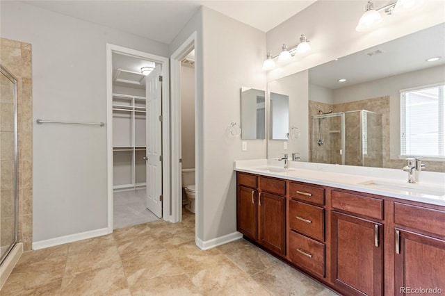 4545 Oxbow Dr, Brighton, CO 80601 - full bathroom featuring a shower stall, toilet, a walk in closet, and double vanity