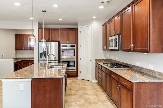 4545 Oxbow Dr, Brighton, CO 80601 - kitchen featuring appliances with stainless steel finishes, a sink, decorative light fixtures, light stone countertops, and recessed lighting