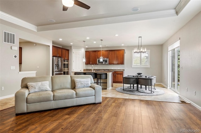 4545 Oxbow Dr, Brighton, CO 80601 - living room featuring hardwood / wood-style flooring, recessed lighting, a ceiling fan, baseboards, and crown molding