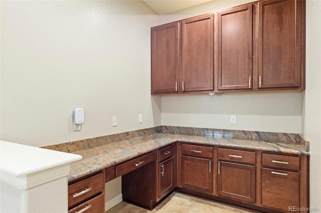 4545 Oxbow Dr, Brighton, CO 80601 - kitchen with built in study area and light stone counters