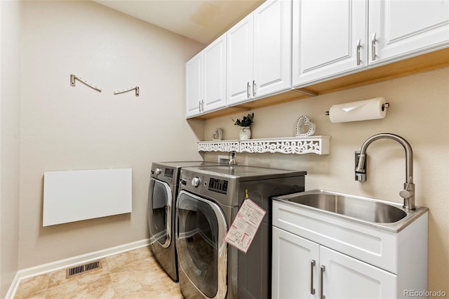 4545 Oxbow Dr, Brighton, CO 80601 - washroom featuring separate washer and dryer, cabinet space, and baseboards