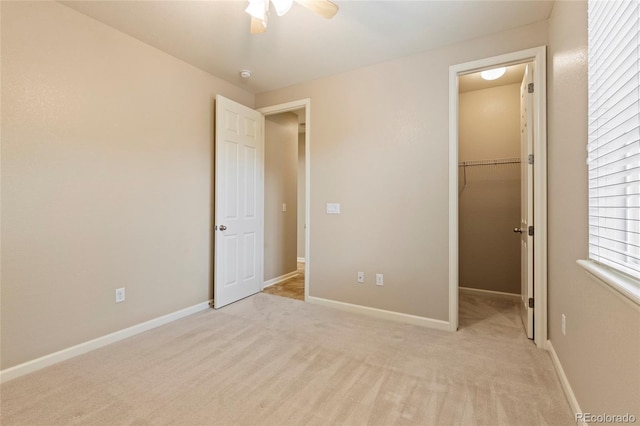4545 Oxbow Dr, Brighton, CO 80601 - unfurnished bedroom with a walk in closet, carpet floors, a ceiling fan, and baseboards