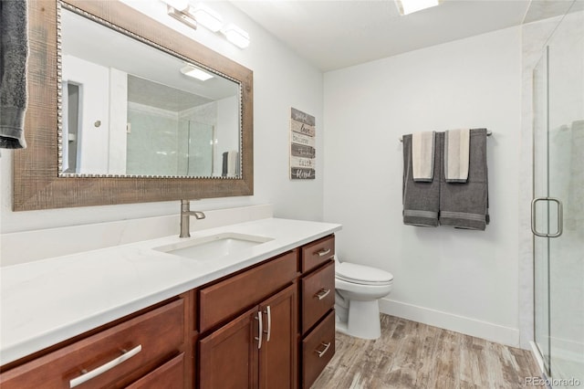 4545 Oxbow Dr, Brighton, CO 80601 - full bath with wood finished floors, a shower stall, vanity, and toilet