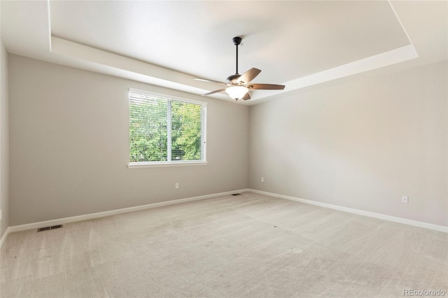 4545 Oxbow Dr, Brighton, CO 80601 - unfurnished room featuring a raised ceiling, ceiling fan, baseboards, and light carpet