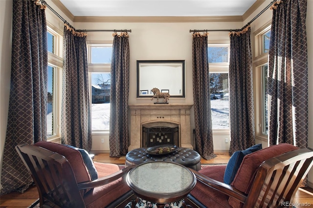 sitting room featuring hardwood / wood-style flooring, ornamental molding, and a wealth of natural light