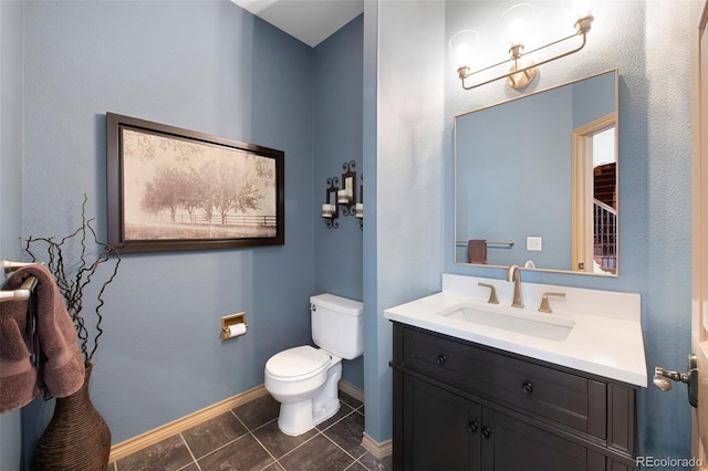 bathroom with vanity, tile patterned floors, and toilet