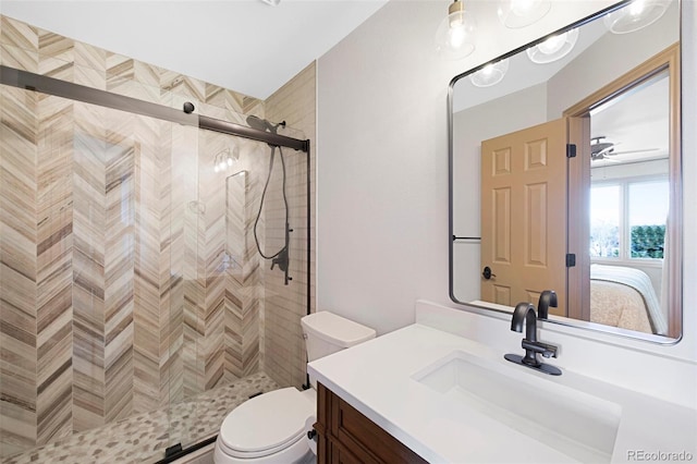 bathroom with vanity, toilet, and a shower with door