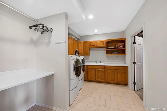 washroom featuring cabinets, sink, and independent washer and dryer