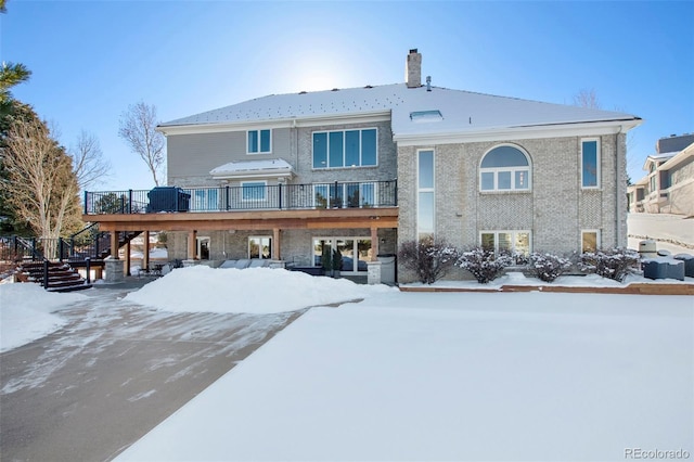 snow covered house with a deck