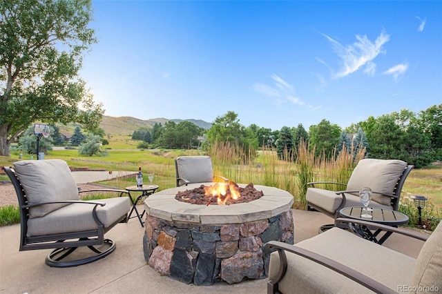 view of patio featuring a mountain view and an outdoor fire pit