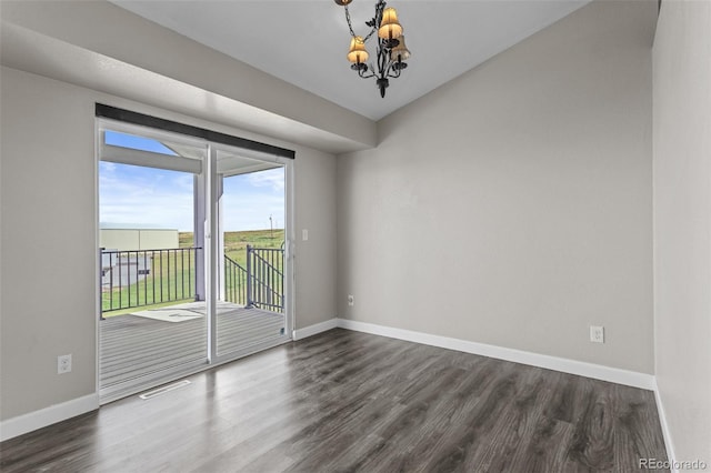 8979 Lariat Loop, Elizabeth, CO 80107 - unfurnished room with dark wood finished floors and a chandelier