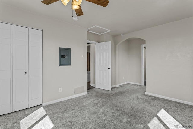 8979 Lariat Loop, Elizabeth, CO 80107 - unfurnished bedroom featuring electric panel, carpet floors, a closet, arched walkways, and a ceiling fan